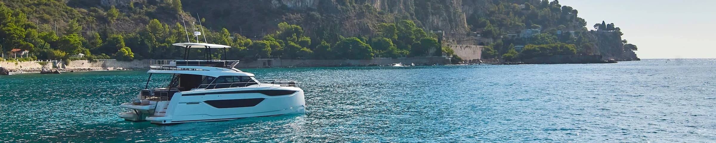 Yachts sailing on lake with emerald-like water