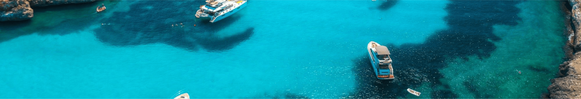 Yachts sailing on lake with emerald-like water